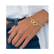 Gold heart charm bangle worn with jeans