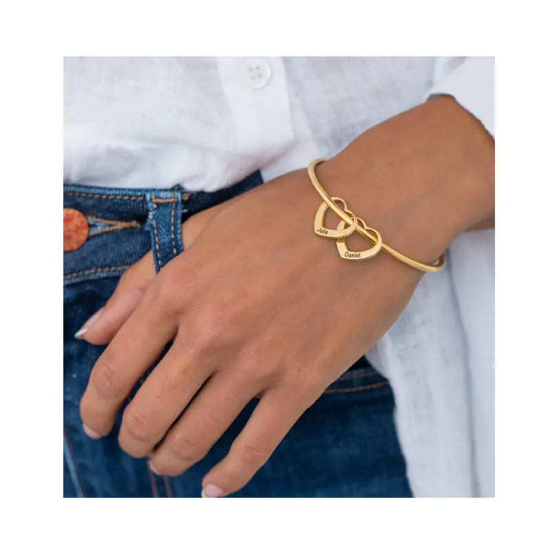 Gold heart charm bangle worn with jeans