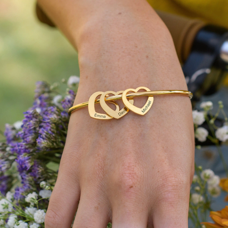 Engraved family heart bangle worn on wrist