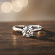 18K Gold Round Cut Lab Grown Diamond Solitaire Engagement Ring on wood
