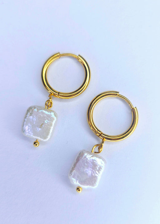 Close-up of irregular square-shaped baroque pearls on Natural White Freshwater Earrings