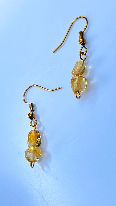 An image featuring a pair of elegant handmade citrine birthstone hook earrings, capturing the warm golden hues of the gemstones against a soft background.