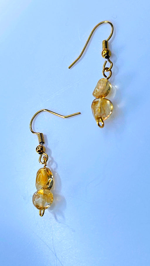 An image featuring a pair of elegant handmade citrine birthstone hook earrings, capturing the warm golden hues of the gemstones against a soft background.