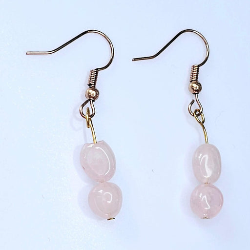 A pair of elegant handcrafted rose quartz dangle earrings, perfect for October birthdays or adding a touch of feminine charm to any outfit.