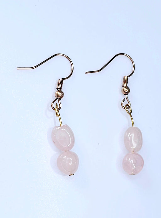A pair of elegant handcrafted rose quartz dangle earrings, perfect for October birthdays or adding a touch of feminine charm to any outfit.