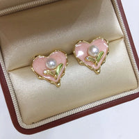 Enamel pink heart-shaped pearl earrings with pearl drop detail