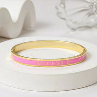 Personalized pink enamel name bangle bracelet with custom cutout detail