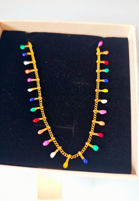 Top view of Rainbow Christmas Light Bulb Necklace in elegant jewelry box